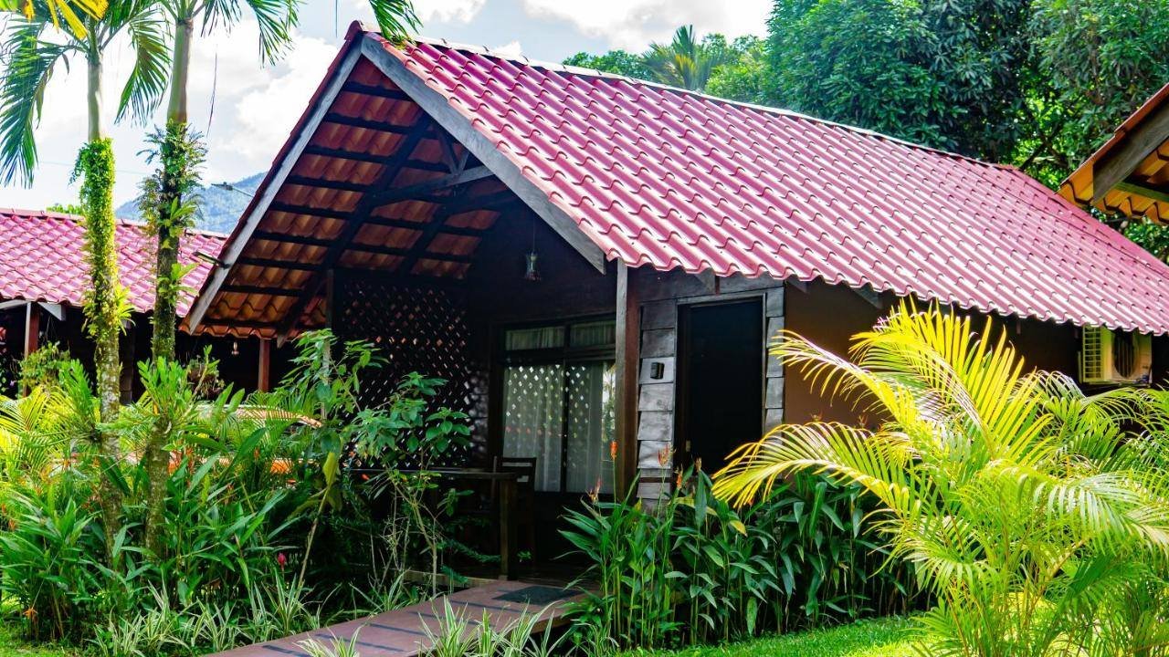La Fortuna Waterfall Bungalows: bungalow with a red tile roof surrounded by tropical plants