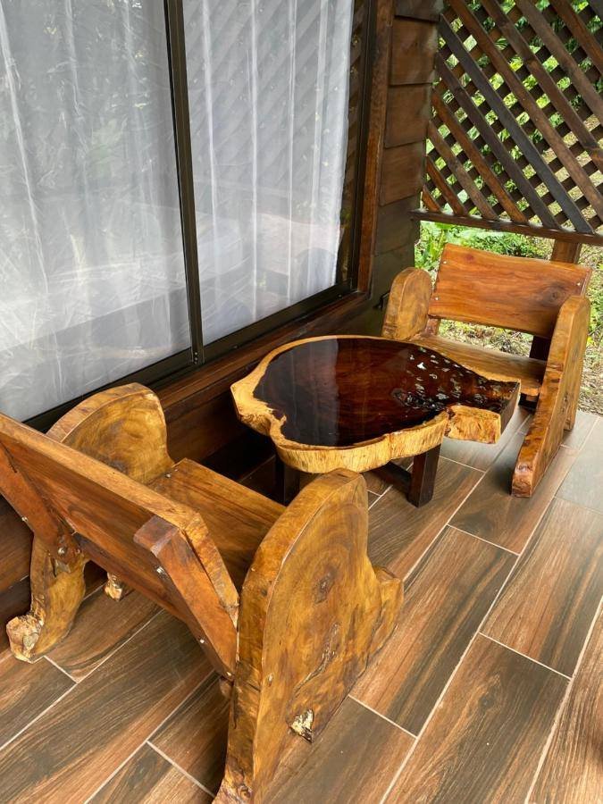 La Fortuna Waterfall Bungalows: sitting area with a carved wooden table by the window